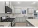 Modern kitchen featuring granite countertops, stainless appliances and ample cabinet space at 3614 Squires Park Ln, Loganville, GA 30052