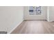 An empty living room with wood floor and chandelier at 3614 Squires Park Ln, Loganville, GA 30052