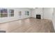 Bright, spacious living room featuring light hardwood floors, a fireplace, large windows, and ample natural light at 3614 Squires Park Ln, Loganville, GA 30052