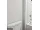 Close-up of a white toilet with a white bathtub and shower in the background featuring a handheld shower at 3623 Squires Park Ln, Loganville, GA 30052