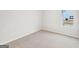 A carpeted bedroom with light walls and a single window at 3623 Squires Park Ln, Loganville, GA 30052