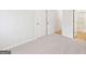 Neutral bedroom featuring plush carpeting and ample closet space with double doors for optimal storage solutions at 3623 Squires Park Ln, Loganville, GA 30052