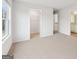 Large bedroom featuring plush carpets, a window, a spacious closet, and easy access to the bathroom and hallway at 3623 Squires Park Ln, Loganville, GA 30052