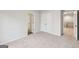 Spacious bedroom featuring plush carpeting, double-door closet, and a doorway to the hallway for easy navigation at 3623 Squires Park Ln, Loganville, GA 30052
