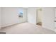 Bedroom boasts a window, plush carpeting, and easy access to the hallway, promoting a welcoming and comfortable atmosphere at 3623 Squires Park Ln, Loganville, GA 30052