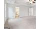 Large bedroom boasts a tray ceiling with a ceiling fan, neutral carpet, and ensuite bathroom at 3623 Squires Park Ln, Loganville, GA 30052