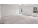 Spacious bedroom features neutral carpet, ceiling fan and two windows for natural light at 3623 Squires Park Ln, Loganville, GA 30052