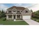 Charming two-story home with brick accents, a two-car garage, and professionally landscaped yard at 3623 Squires Park Ln, Loganville, GA 30052