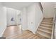 Bright foyer with light walls, wood-look flooring, and a staircase with carpet runner at 3623 Squires Park Ln, Loganville, GA 30052