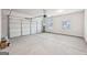 Spacious two-car garage with white door, overhead lighting, and concrete flooring, offering ample storage and parking at 3623 Squires Park Ln, Loganville, GA 30052