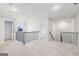 Open hallway boasts neutral carpet, decorative lighting, and wrought iron railing enhancing the architectural appeal at 3623 Squires Park Ln, Loganville, GA 30052