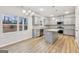 This kitchen has stainless appliances, gray cabinets and light countertops with an island at 3623 Squires Park Ln, Loganville, GA 30052