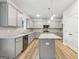 This kitchen has stainless appliances, gray cabinets and light countertops with an island at 3623 Squires Park Ln, Loganville, GA 30052