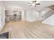 Spacious open-concept living room with hardwood floors, a staircase, and a modern kitchen at 3623 Squires Park Ln, Loganville, GA 30052