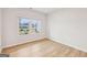 A light and bright living room with wood-look floors and a large picture window at 3623 Squires Park Ln, Loganville, GA 30052