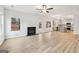 Expansive living room featuring hardwood floors, a fireplace, and an open layout to the modern kitchen at 3623 Squires Park Ln, Loganville, GA 30052