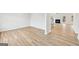 Open-concept living room with hardwood floors, fireplace, and staircase, perfect for Gathering gatherings at 3623 Squires Park Ln, Loganville, GA 30052