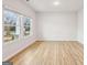 A light and bright living room with wood-look floors and a large picture window at 3623 Squires Park Ln, Loganville, GA 30052