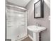 Well-lit bathroom featuring a walk-in shower, sleek sink, and modern mirror at 644 Albert Nw St, Atlanta, GA 30318