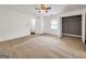 Bedroom featuring window, closet, neutral carpet, and ceiling fan at 644 Albert Nw St, Atlanta, GA 30318