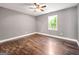 Bright bedroom with hardwood floors and a view of lush landscaping at 644 Albert Nw St, Atlanta, GA 30318