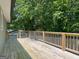 Large, wooden backyard deck surrounded by lush, mature trees at 644 Albert Nw St, Atlanta, GA 30318