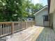 Wide-angle view of the wood backyard deck that has access to a side door at 644 Albert Nw St, Atlanta, GA 30318