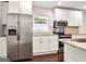 Modern kitchen features stainless steel appliances, white cabinetry, and a tile backsplash at 644 Albert Nw St, Atlanta, GA 30318