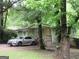 Exterior view of a cozy home featuring lush trees, porch entry and convenient parking at 118 Tye St, Stockbridge, GA 30281
