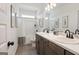 Well-lit bathroom with double sinks, elegant dark hardware, and framed artwork at 2 Silver Leaf Trl, Douglasville, GA 30134