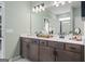 Double vanity with bronze fixtures, light green walls, and a large mirror at 2 Silver Leaf Trl, Douglasville, GA 30134