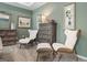 Beautiful bedroom featuring two chairs and an ottoman with a light green wall at 2 Silver Leaf Trl, Douglasville, GA 30134