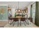 An open dining room features hardwood floors, a wooden table, and modern accents at 2 Silver Leaf Trl, Douglasville, GA 30134