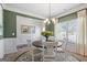 Bright dining room with a round table, white chairs, decorative rug, and natural light from the window at 2 Silver Leaf Trl, Douglasville, GA 30134