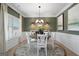 Elegant dining room featuring a chandelier, decorative mirror, buffet, and a neutral color palette at 2 Silver Leaf Trl, Douglasville, GA 30134
