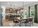 Open dining room with a wooden table set, kitchen island and stainless steel appliances at 2 Silver Leaf Trl, Douglasville, GA 30134