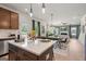 Kitchen island with stainless steel appliances, a dining area, and a living room at 2 Silver Leaf Trl, Douglasville, GA 30134