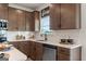 Kitchen with stainless steel appliances, dark wood cabinets and white subway tile at 2 Silver Leaf Trl, Douglasville, GA 30134