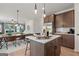 Open concept kitchen with stainless steel appliances and center island adjoining dining area at 2 Silver Leaf Trl, Douglasville, GA 30134