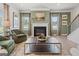Inviting living room featuring a fireplace, neutral decor, comfortable seating, and a view of the staircase at 2 Silver Leaf Trl, Douglasville, GA 30134