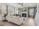 Cozy living room with a fireplace, neutral decor, large windows, and an open view to the backyard at 2 Silver Leaf Trl, Douglasville, GA 30134