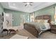 Spacious main bedroom featuring a tray ceiling, and a large bed with two chairs at 2 Silver Leaf Trl, Douglasville, GA 30134