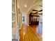 Hallway featuring hardwood floors, built-in shelving, and archways leading to various living spaces at 345 Peaceful Way, Fayetteville, GA 30214