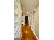 Hallway with hardwood floors, arched doorways, and built-in shelving, offering a grand feel at 345 Peaceful Way, Fayetteville, GA 30214