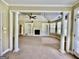 Bright living room featuring built-in bookshelves, fireplace, and ceiling fan at 345 Peaceful Way, Fayetteville, GA 30214