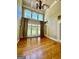 Bright living room with soaring ceilings, large windows, hardwood floors, and custom built-ins at 345 Peaceful Way, Fayetteville, GA 30214