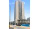 The condo building exterior is modern and sleek, with a view of city streets and ongoing construction at 1280 W Peachtreestreetsuffix=Street Nw # 808, Atlanta, GA 30309