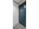 Close-up of a dark teal condo unit door featuring four raised panels and classic hardware at 1280 W Peachtreestreetsuffix=Street Nw # 808, Atlanta, GA 30309
