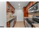 Charming kitchen featuring granite countertops, stainless steel appliances, and wood cabinets at 1280 W Peachtreestreetsuffix=Street Nw # 808, Atlanta, GA 30309