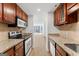 Kitchen featuring granite countertops and stainless steel appliances with an open view to the living area at 1280 W Peachtreestreetsuffix=Street Nw # 808, Atlanta, GA 30309